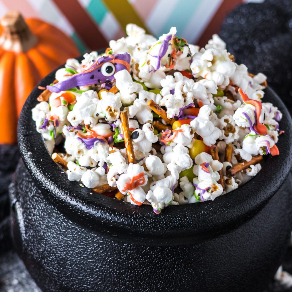 black cauldron filled with monster munch halloween popcorn mix