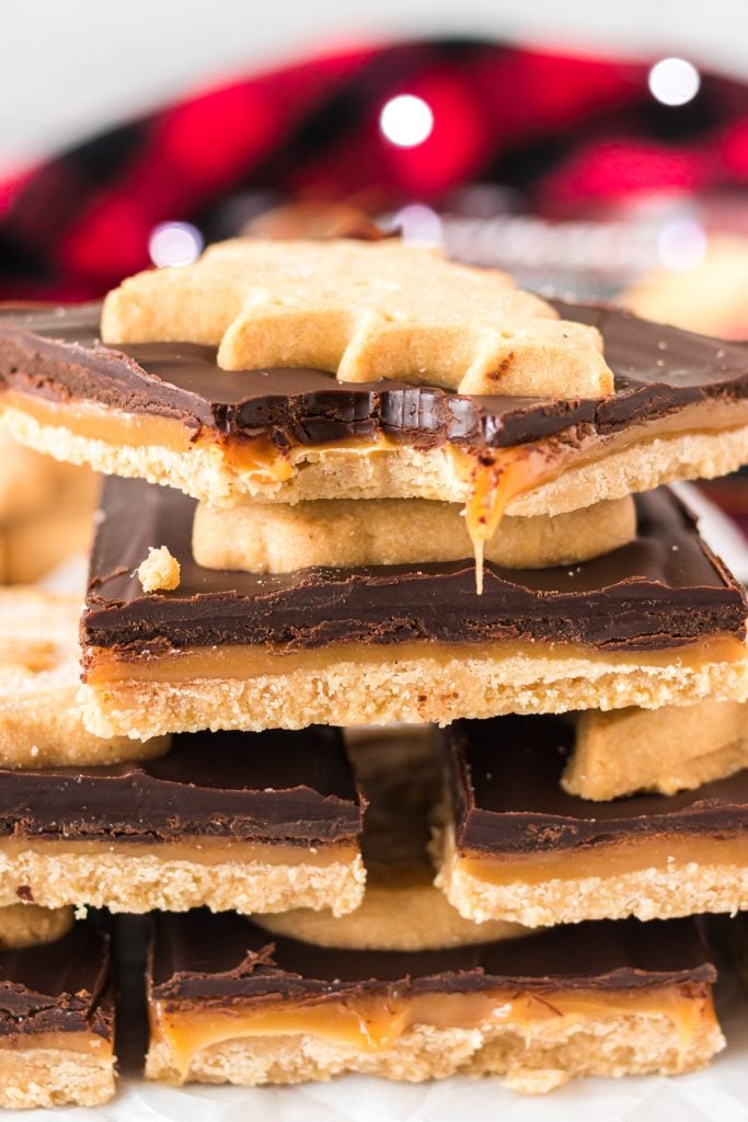 stack of millionaire bars with a bite taken out of the top bar with drippy caramel