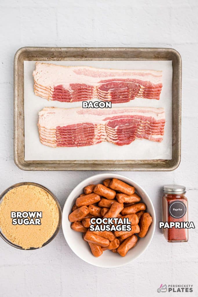 overhead shot of labeled ingredients laid out to make bacon wrapped cocktail sausages.