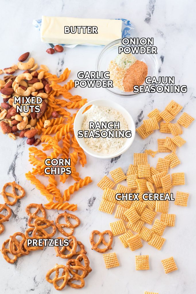 overhead shot of labeled ingredients laid out to make cajun chex mix
