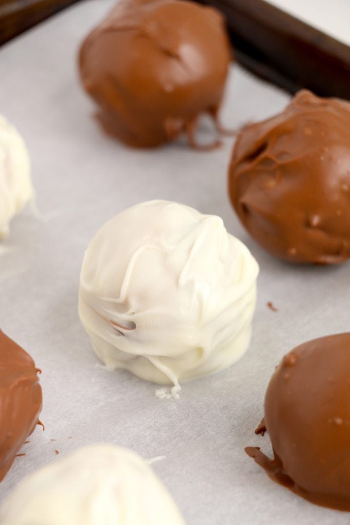 a white chocolate dipped cookie dough truffle