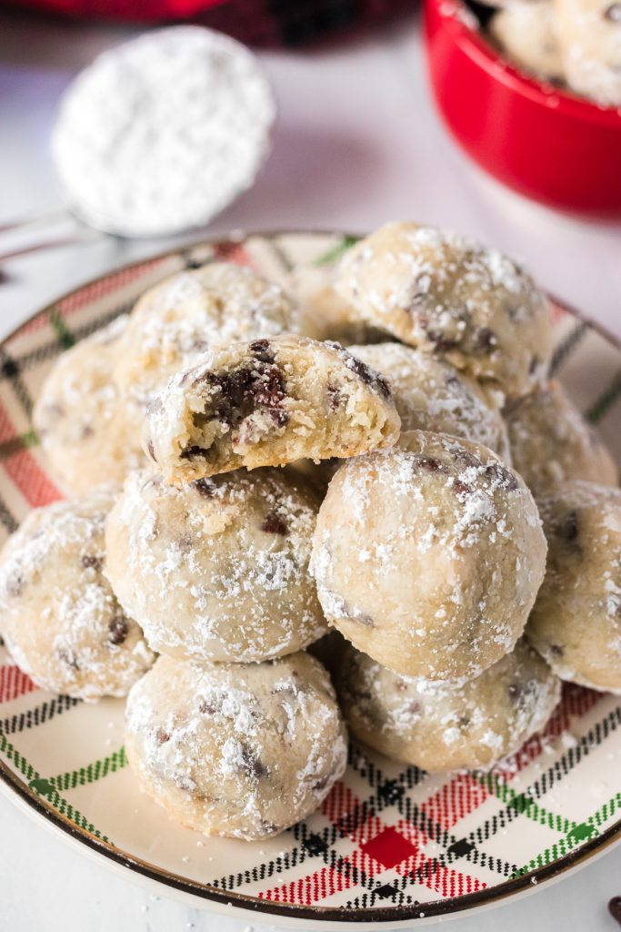 stack of chocolate chip snowball cookies on a plaid plate