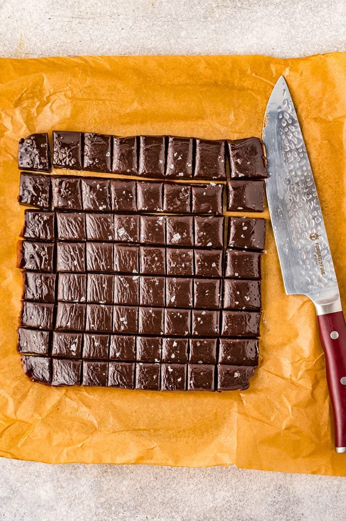 overhead shot of chocolate caramels being cut into small pieces