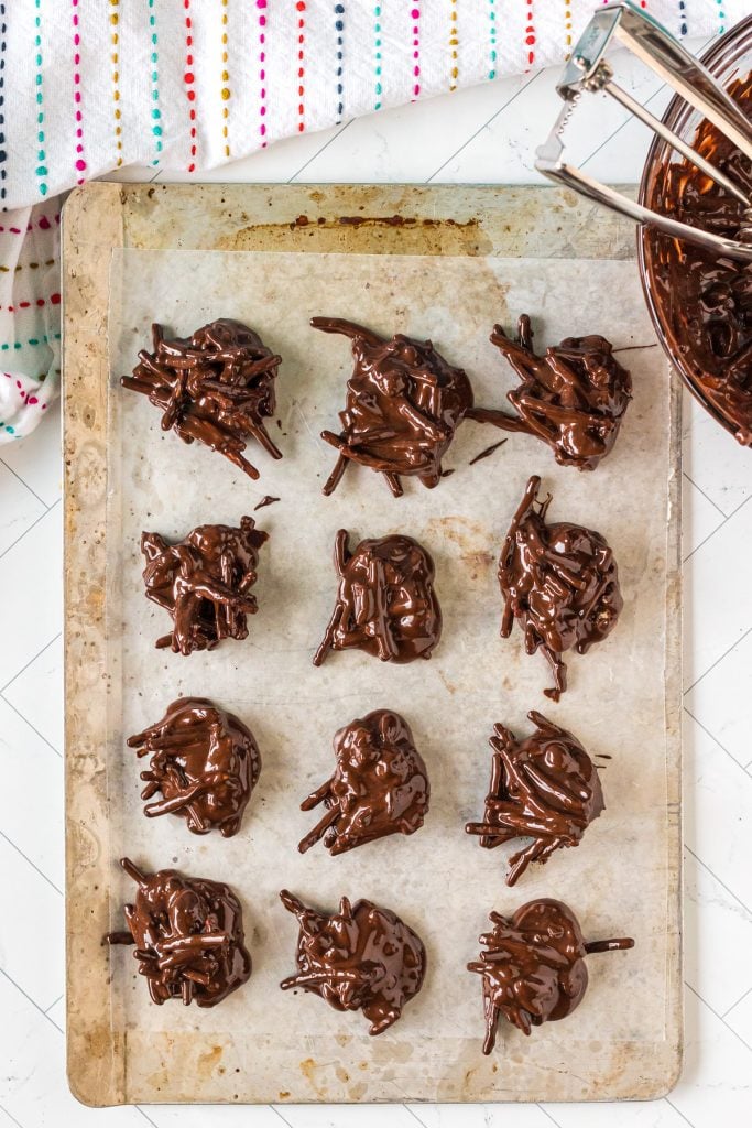 overhead shot of chocolate haystacks being scooped onto a baking sheet