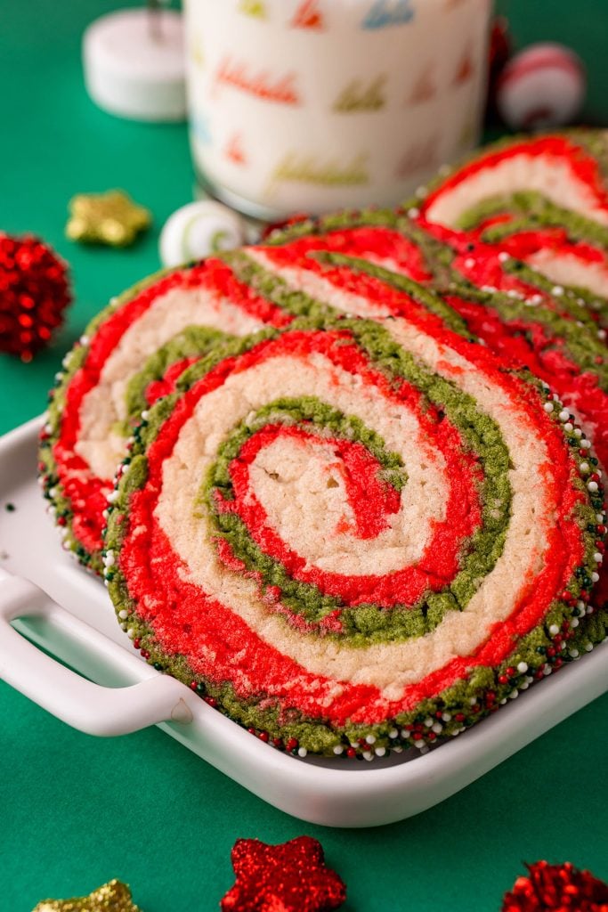 closeup of a red & green christmas pinwheel sugar cookie on a plate