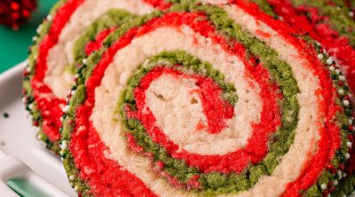 closeup of christmas pinwheel cookie topped with sprinkles