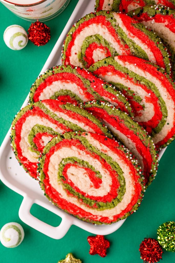 red white & green christmas pinwheel sugar cookies on a white platter