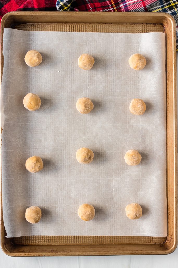 peanut butter cookie balls on a baking sheet