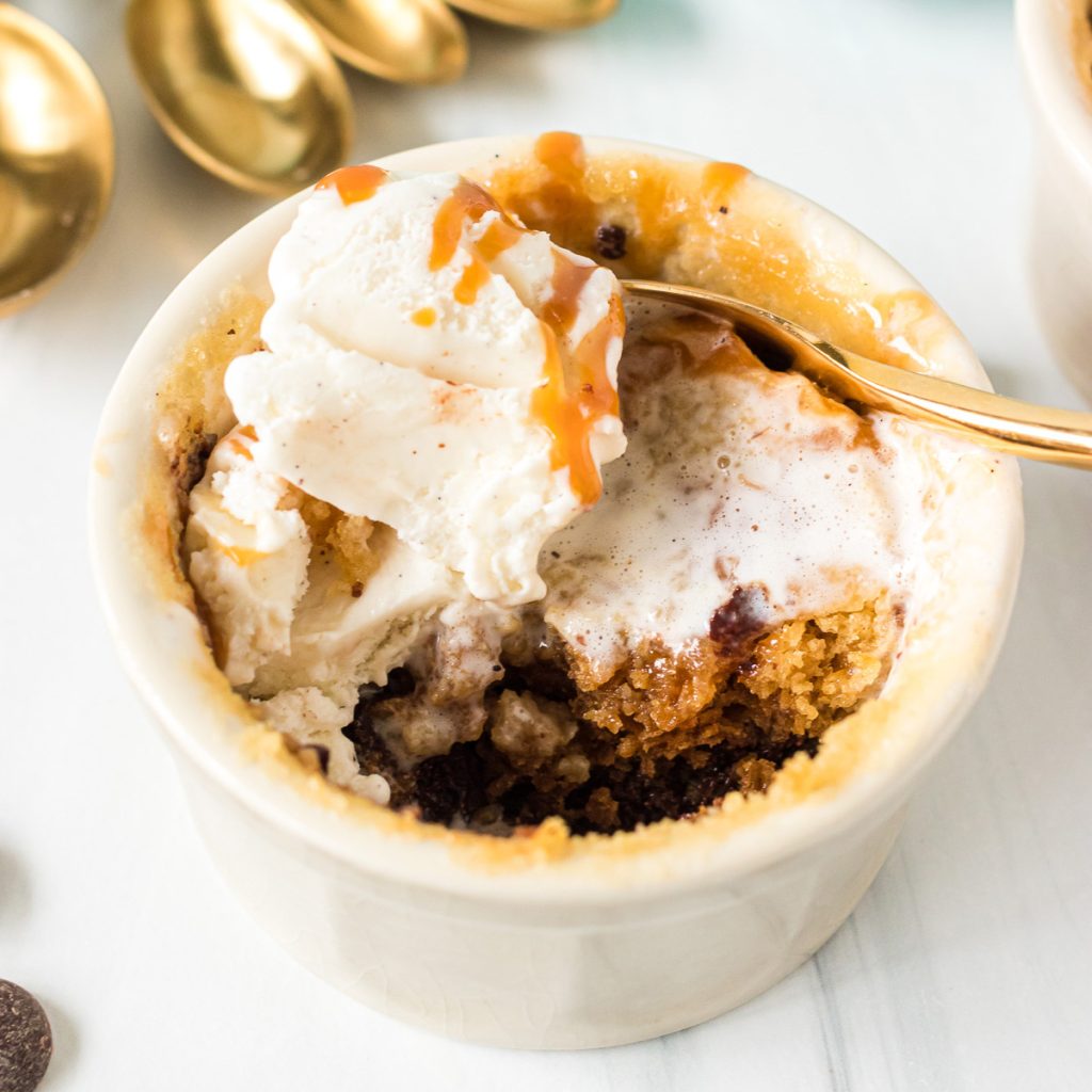 microwave chocolate chip cookie in a ramekin topped with vanilla ice cream 