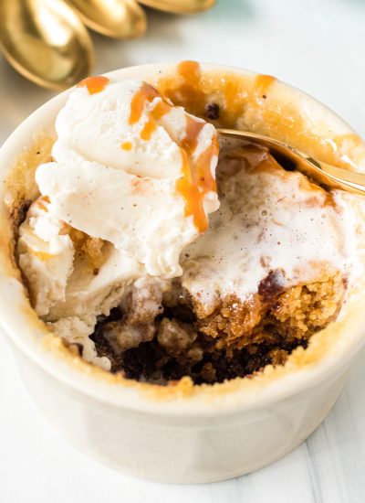 microwave chocolate chip cookie in a ramekin topped with vanilla ice cream