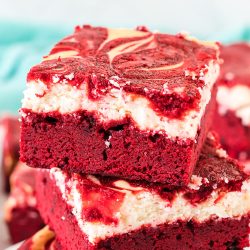 side view of a stack of red velvet cheesecake brownies.