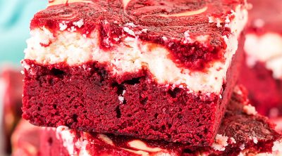 side view of a stack of red velvet cheesecake brownies.