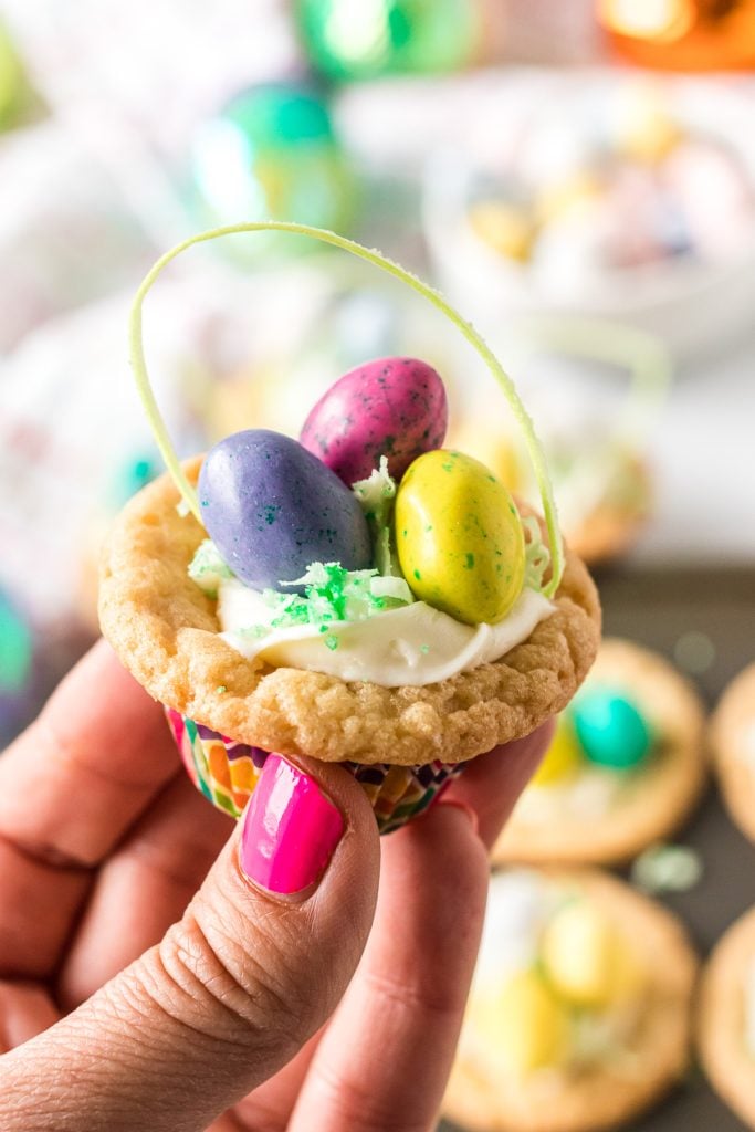 hand holding an easter basket cookie cup. 