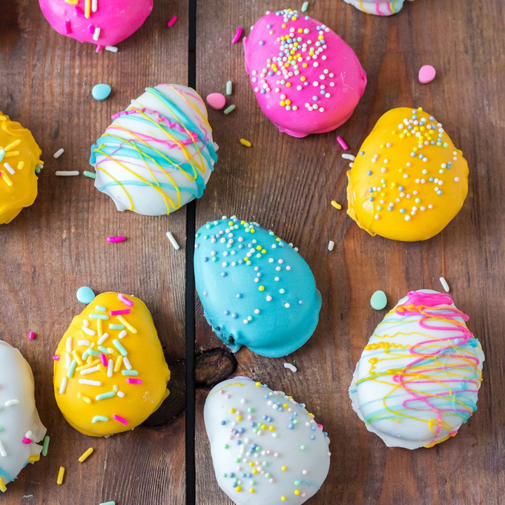 overhead shot of colorful easter egg truffles on a wood board.