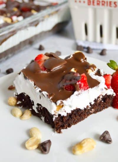 plate of layered brownie delight dessert topped with chocolate.