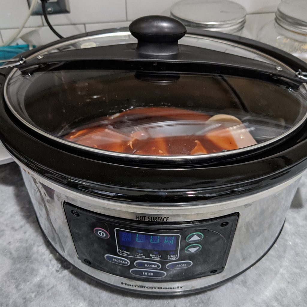 hamilton beach slow cooker filled with chicken.