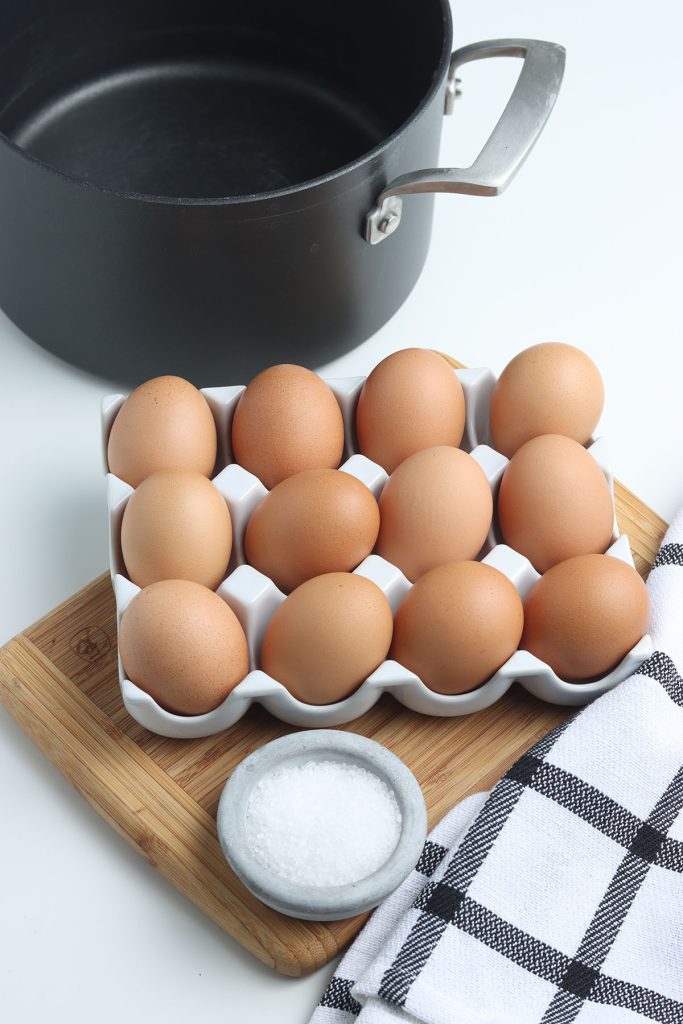 brown eggs, salt, and pot laid out to boil eggs.