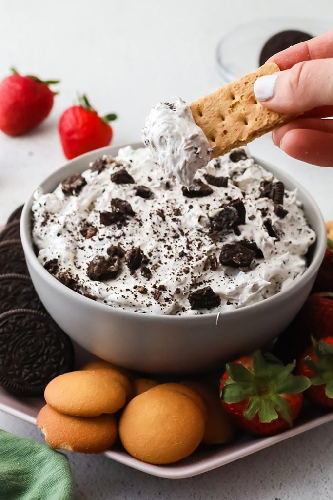 a graham cracker scooping out oreo dip.