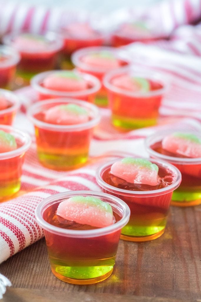 layered watermelon jello shots topped with a sour candy.