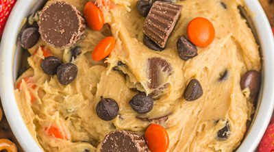 closeup overhead shot of peanut butter cup cookie dough dip topped with mini peanut butter cups.