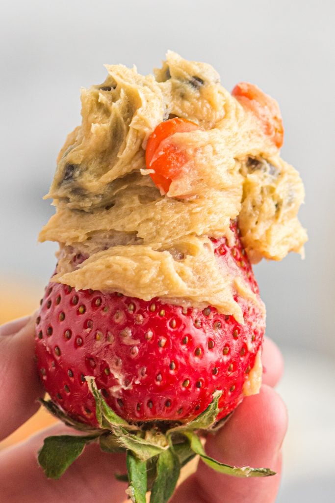a strawberry dipped in peanut butter dip.