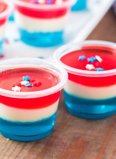 red white & blue jello shots with star sprinkles on top.