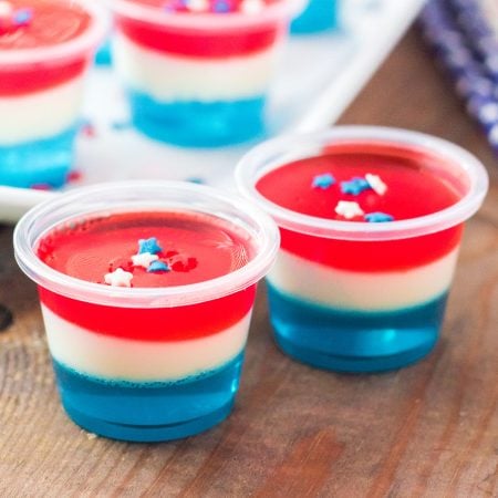 red white & blue jello shots with star sprinkles on top.