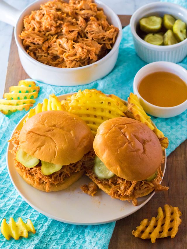 overhead shot of two hot honey chicken sandwiches on a plate next to waffle fries.