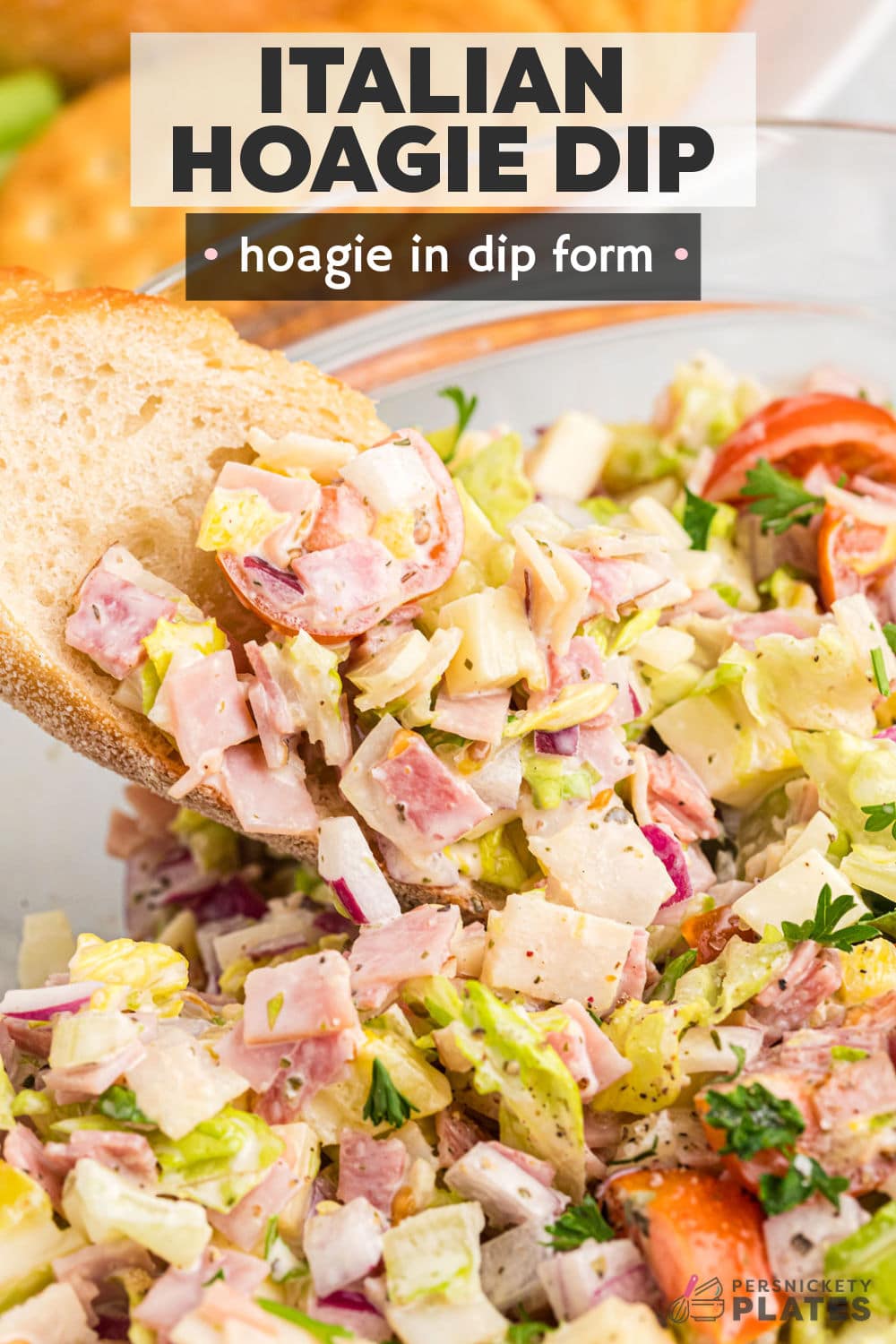 This easy Hoagie Dip takes everything you love about an authentic Italian hoagie and turns it into delicious dip form. All the deli meat and cheeses chopped and tossed with a creamy Italian dressing and scooped up with crusty baguette slices. Skip the sub shop and make this at home for a new favorite! | www.persnicketyplates.com
