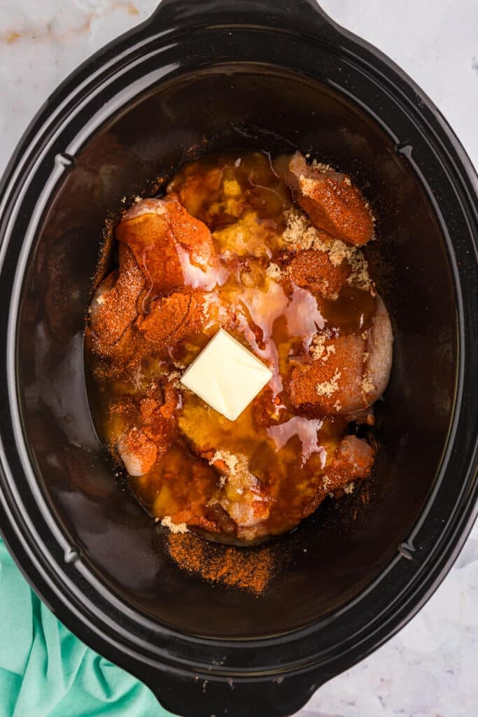 butter and honey on chicken in a crockpot.