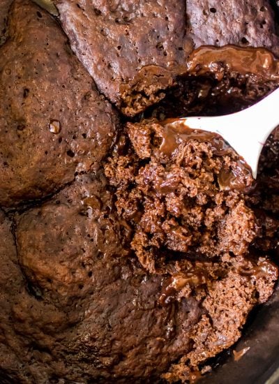 spoon scooping lava cake from a crockpot.