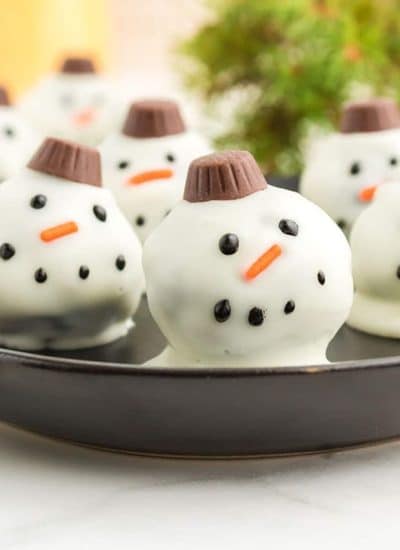 plate of oreo balls decorated as snowmen.