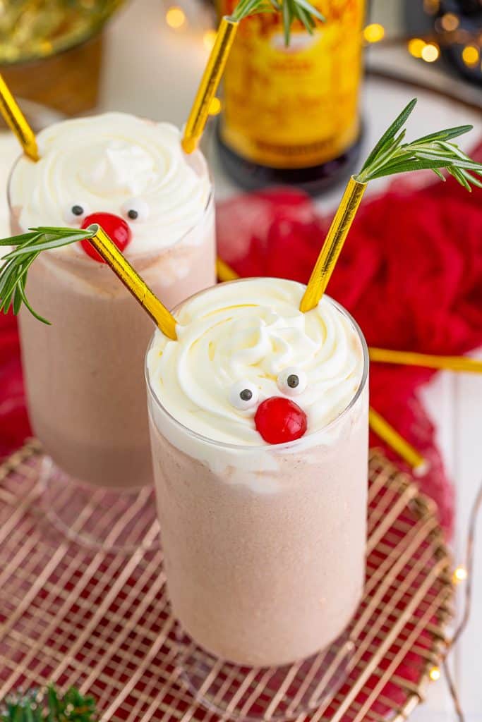 milkshake topped with candy eyeballs, cherry, and straw antlers.