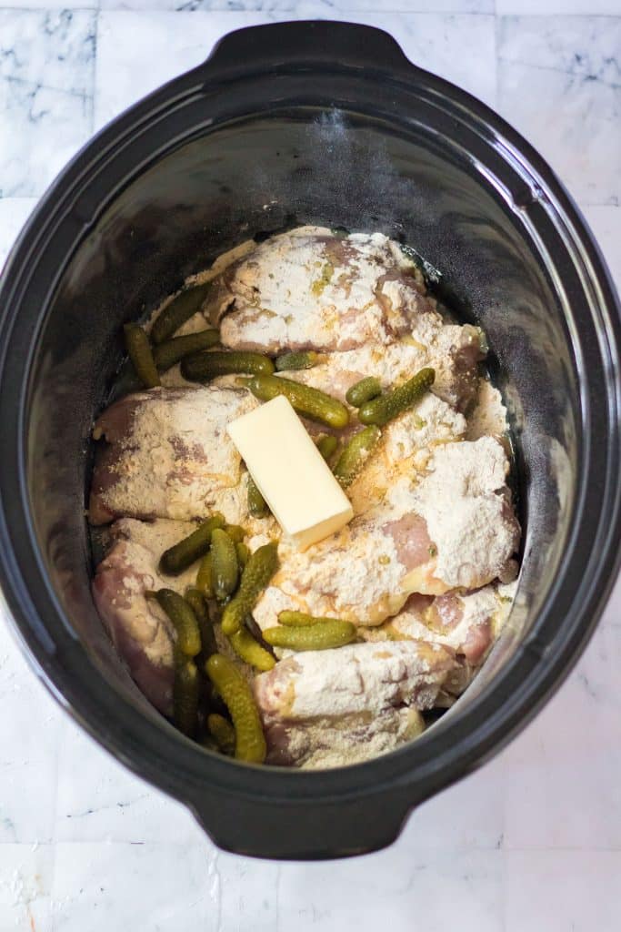 overhead shot of dill pickle chicken in a slow cooker.