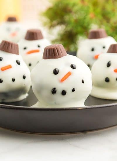 plate of oreo balls decorated as snowmen.