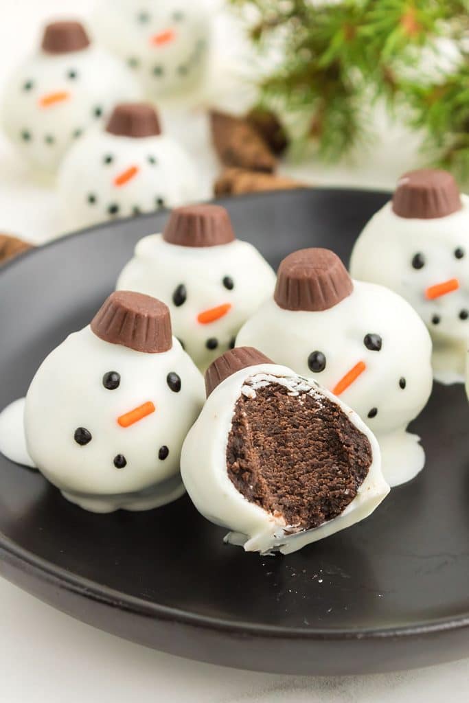 an snowman oreo ball with a bite taken out of it.