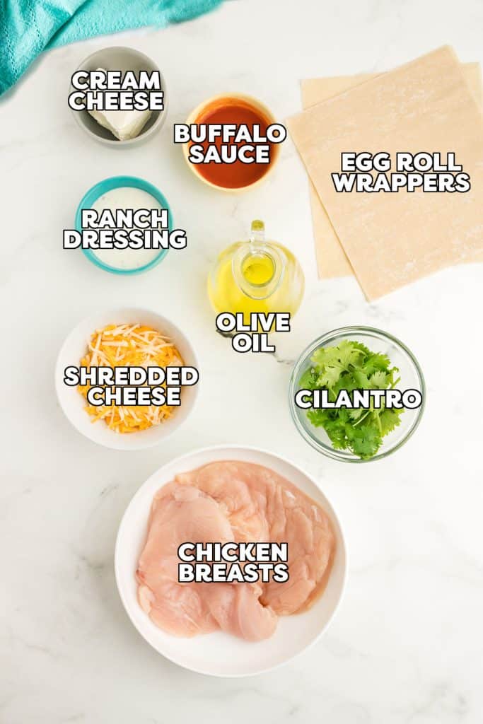 overhead shot of labeled ingredients for buffalo chicken egg rolls.