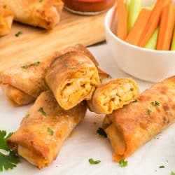 buffalo chicken egg roll sliced open and stacked on one another.