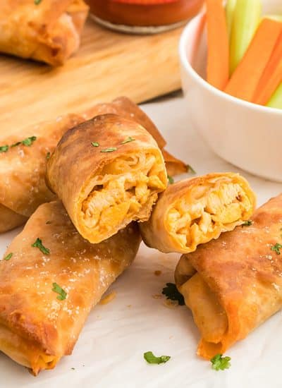 buffalo chicken egg roll sliced open and stacked on one another.