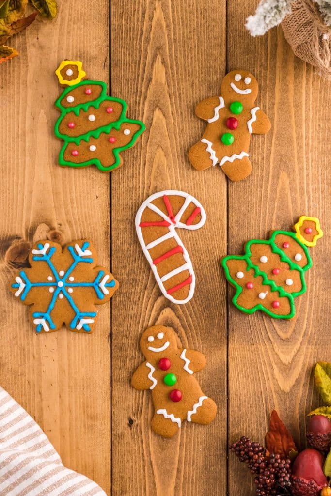 overhead shot of decorated gingerbread cookies on a wooden table.