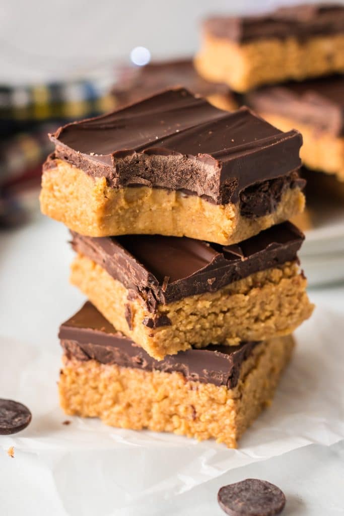 stack of 3 peanut butter bars with a bite out of the top one.