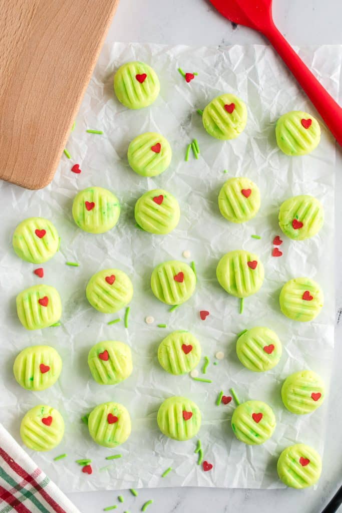 overhead shot of green cream cheese mints with heart sprinkles.