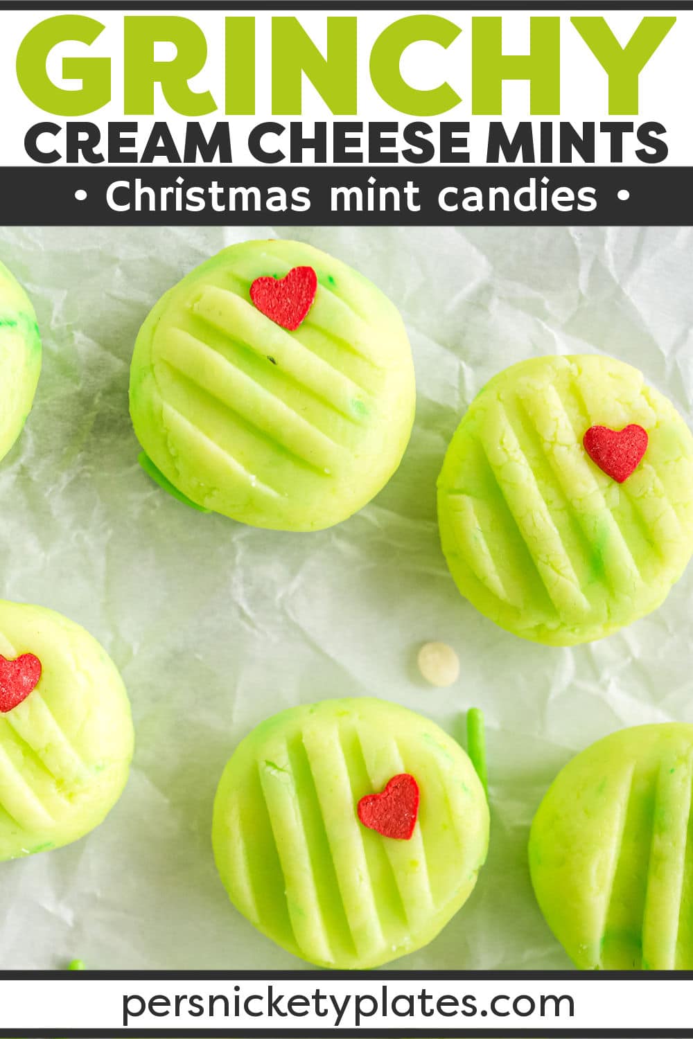 These simple Grinch-themed Christmas cream cheese mints are super cute and made with only six ingredients. The classic Christmas mints are dyed a Grinchy green and topped with a red heart sprinkle. | www.persnicketyplates.com