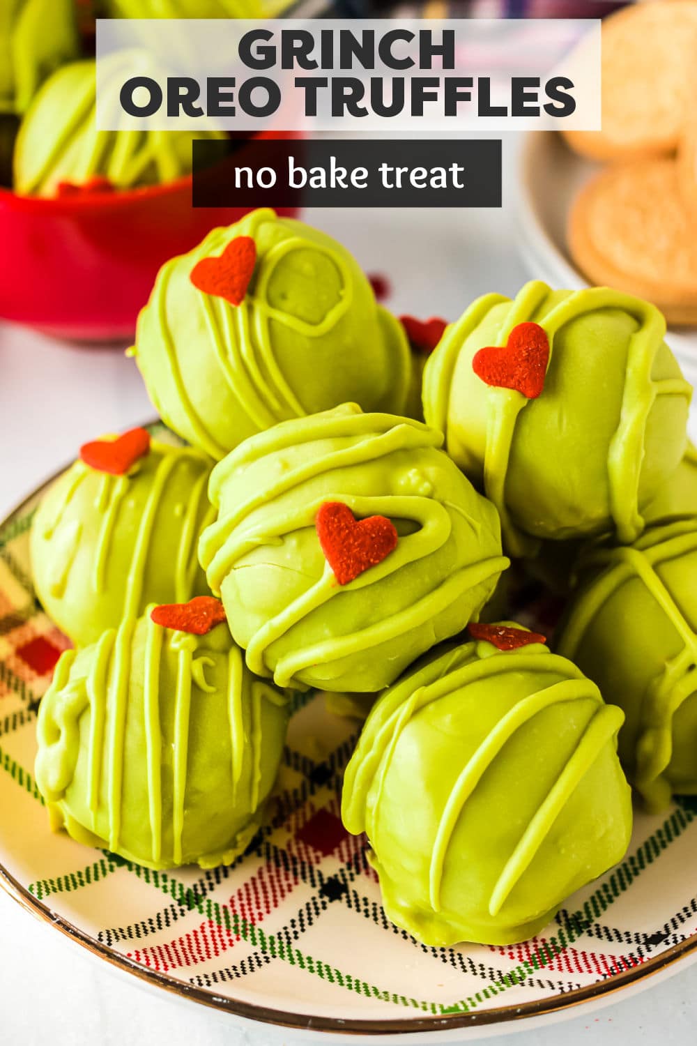 Four ingredient Grinch Oreo Truffles are easily made with golden Oreos, cream cheese, and sprinkles. Dipped in green candy melts and topped with a tiny red heart-shaped sprinkle, this no-bake treat is the perfect addition to your holiday cookie tray! | www.persnicketyplates.com