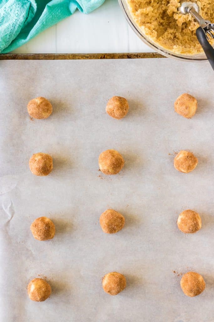 overhead shot of cookie dough balls on a baking sheet.
