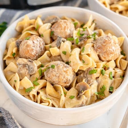white bowl of meatball stroganoff with egg noodles.