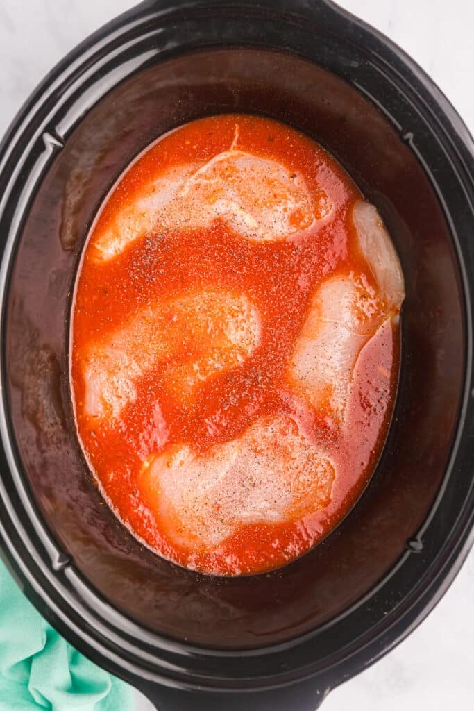chicken breasts in marinara in a crockpot.