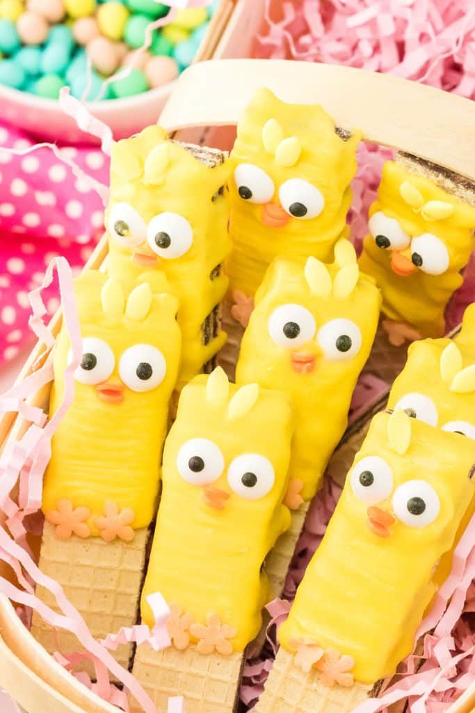 basket of cookies decorated like easter chicks.