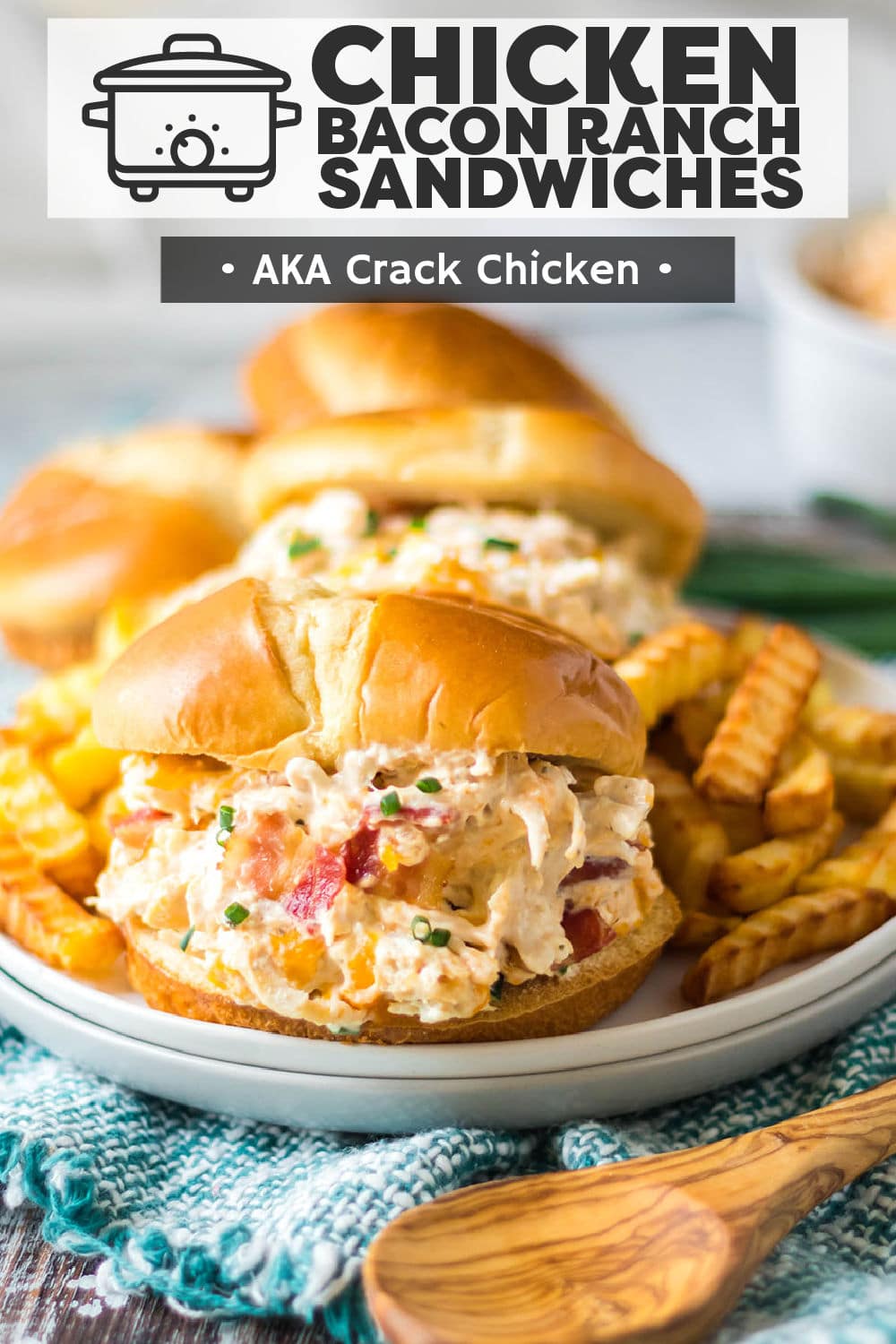 Slow Cooker Chicken Bacon Ranch Sandwiches (aka Crack Chicken) are an easy hit!  Chicken, cream cheese, and ranch seasoning cook together in the crockpot before getting mixed with cheddar, bacon, and scallions and then piled onto soft buns. | www.persnicketyplates.com