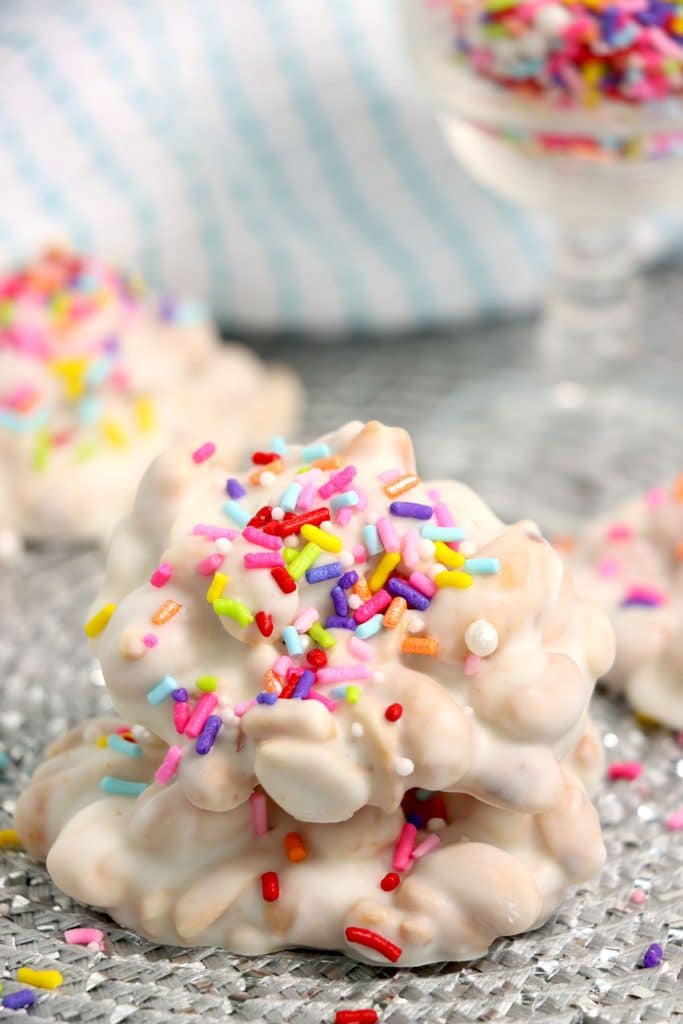 white chocolate peanut clusters with rainbow sprinkles.